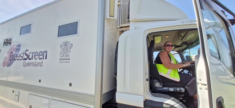 A woman sits behind the wheel of the BreastScreen bus