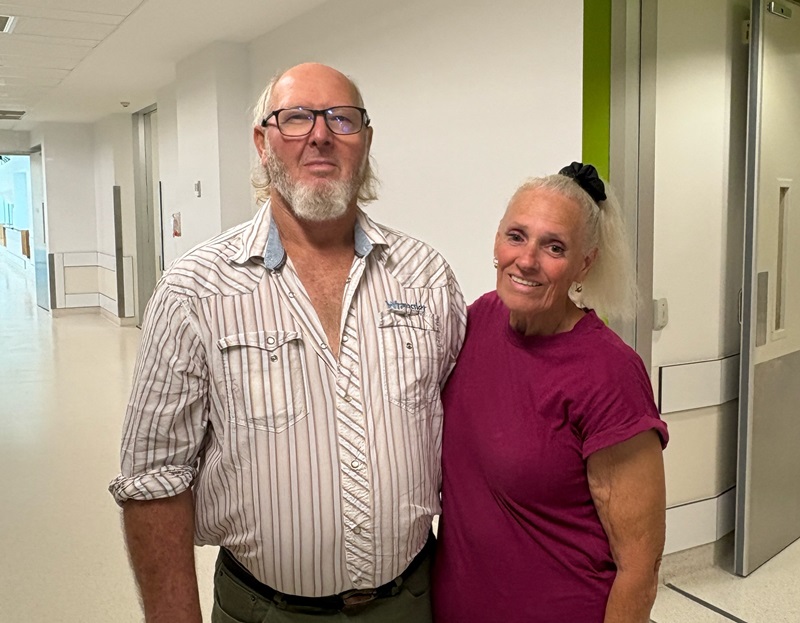 A bearded man with his wife stands outside the cardiac unit