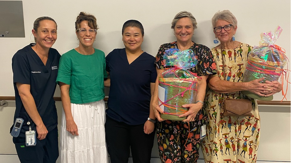 Two family members present a gift to a doctor and two nursing staff from the renal unit 